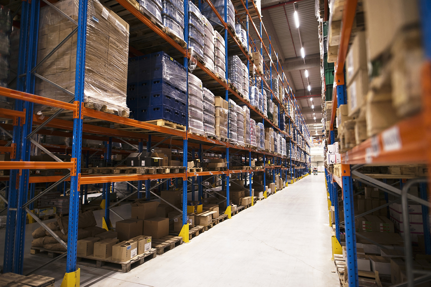 interior-large-distribution-warehouse-with-shelves-stacked-with-palettes-goods-ready-market